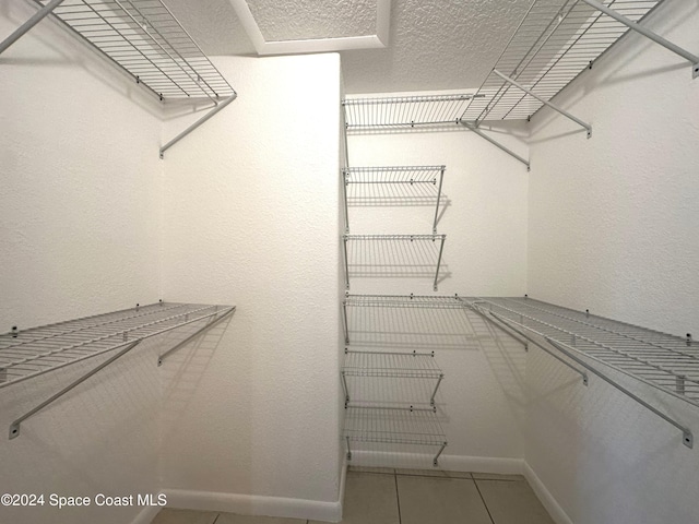 spacious closet with tile patterned floors