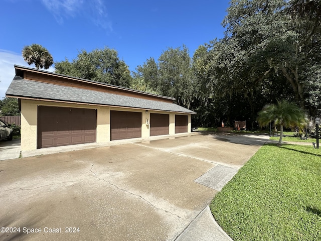 garage featuring a lawn