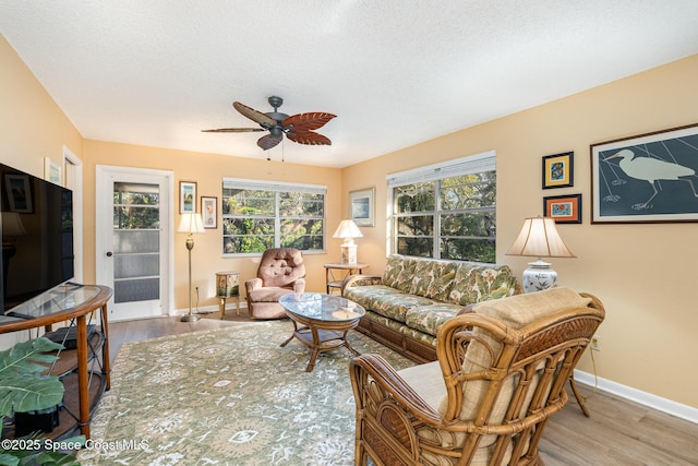 living room with ceiling fan and light wood-type flooring