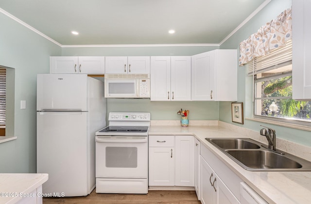 kitchen featuring white appliances, white cabinetry, and sink