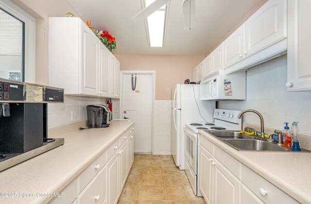 kitchen featuring backsplash, white appliances, sink, white cabinets, and light tile patterned flooring