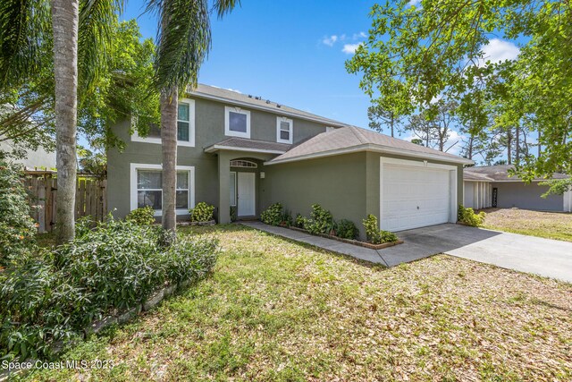 view of front of home featuring a front yard and a garage