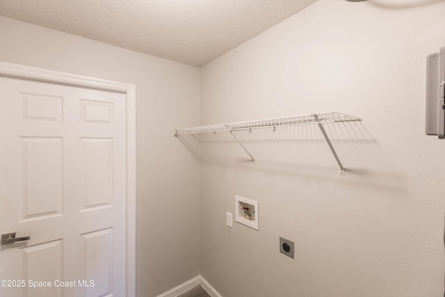 laundry room with electric dryer hookup, hookup for a washing machine, and a textured ceiling