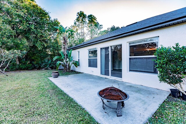 view of yard featuring a patio area and an outdoor fire pit