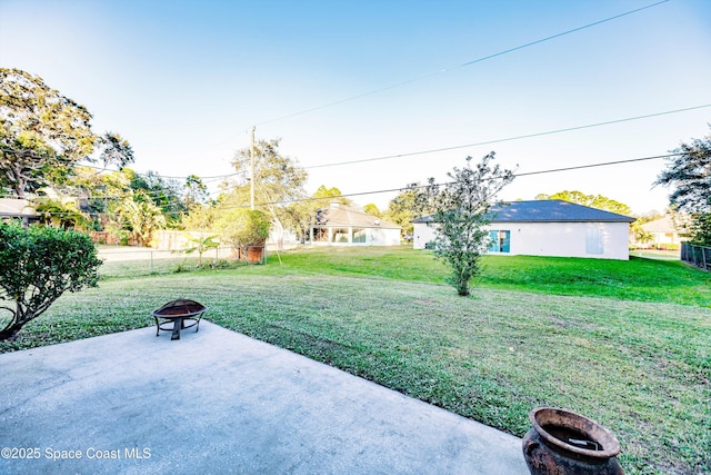 view of yard with an outdoor fire pit and a patio