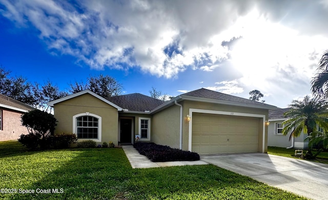 ranch-style house featuring a garage and a front lawn