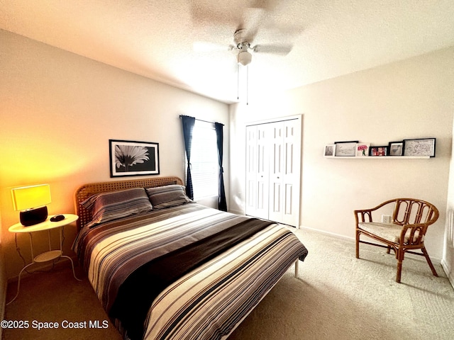 carpeted bedroom featuring ceiling fan, a closet, and a textured ceiling