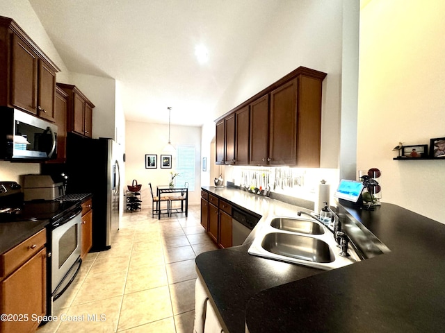 kitchen with sink, light tile patterned floors, pendant lighting, and appliances with stainless steel finishes