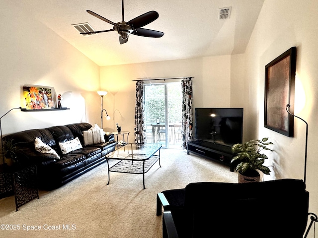 carpeted living room with ceiling fan and vaulted ceiling