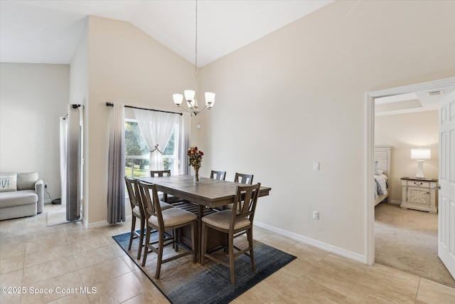 tiled dining room with high vaulted ceiling and a chandelier