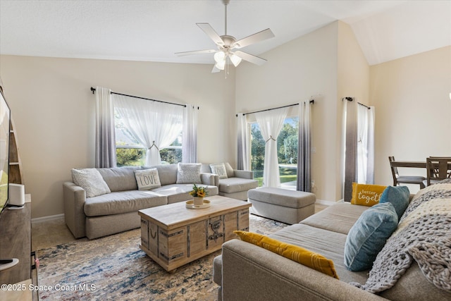 living room featuring ceiling fan and lofted ceiling