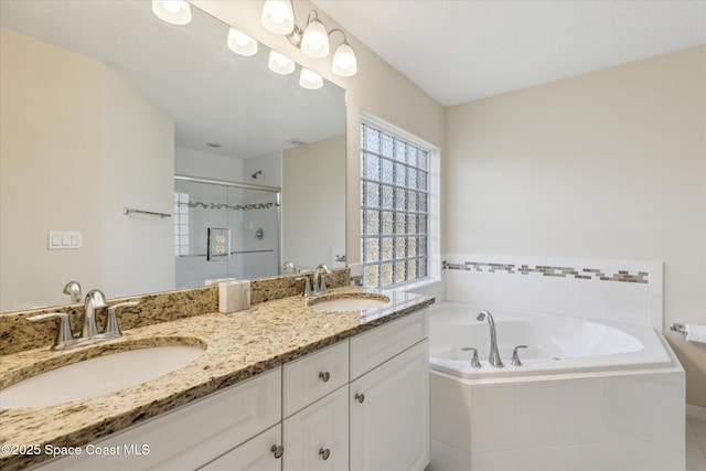 bathroom with vanity and independent shower and bath