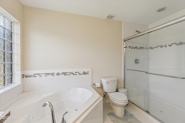 bathroom featuring tile patterned flooring, shower with separate bathtub, and toilet