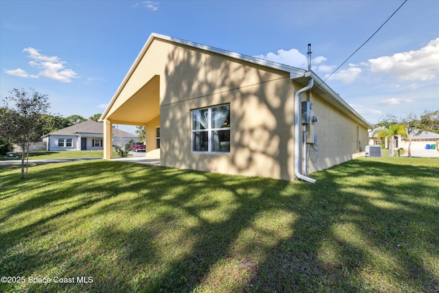 view of property exterior featuring a lawn and central AC