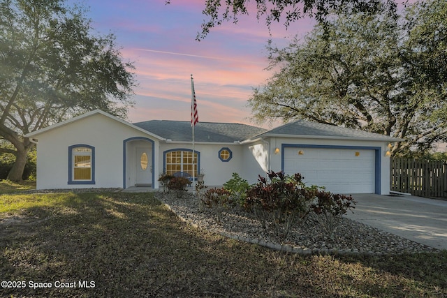 ranch-style home with a lawn and a garage