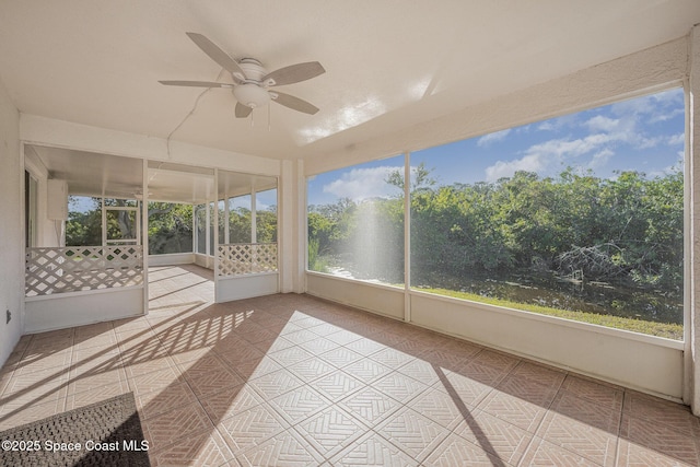 unfurnished sunroom with ceiling fan