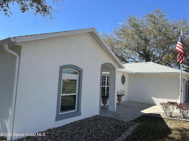 property entrance with stucco siding