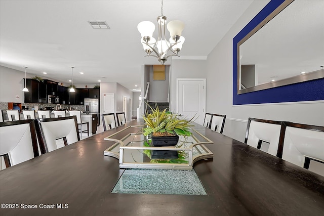 dining space with an inviting chandelier