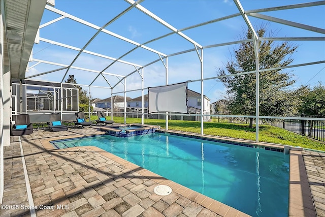 view of pool featuring glass enclosure, an in ground hot tub, a yard, and a patio