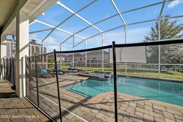 view of swimming pool with glass enclosure, a patio area, and an in ground hot tub