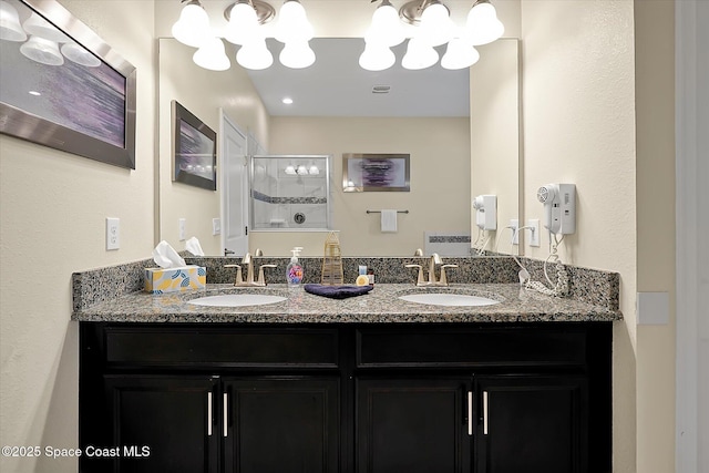 bathroom with vanity and a shower with shower door