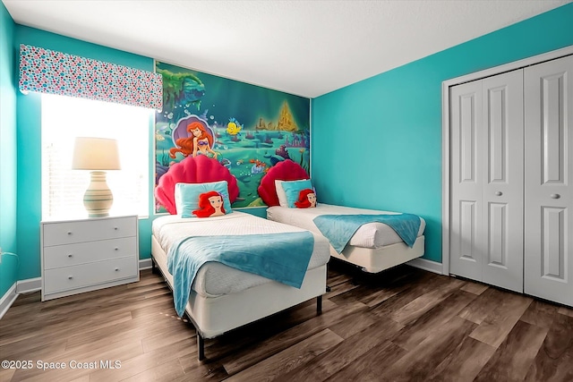 bedroom with a closet and dark wood-type flooring