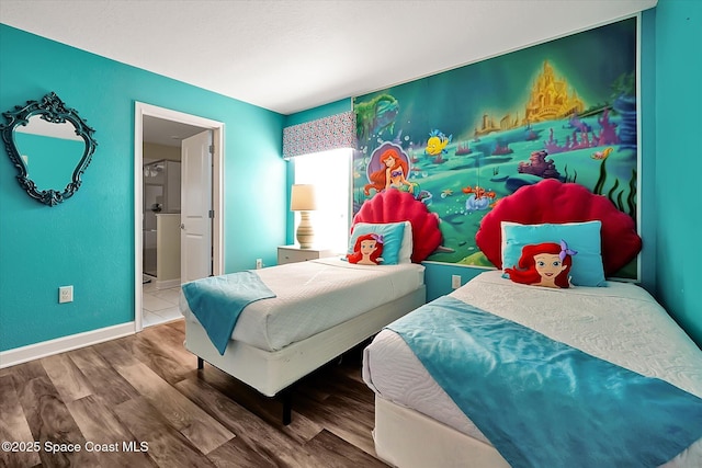 bedroom featuring hardwood / wood-style flooring and ensuite bath