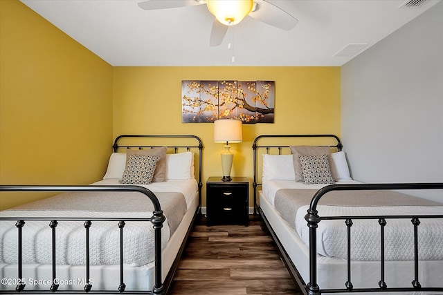 bedroom with ceiling fan and dark hardwood / wood-style floors