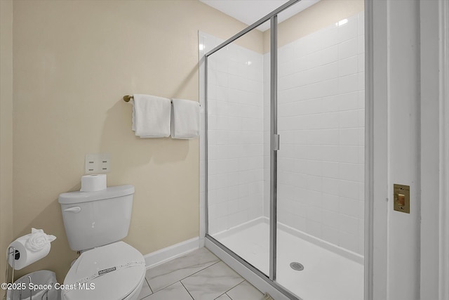 bathroom with toilet and a shower with shower door