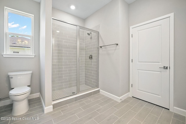 bathroom featuring toilet and walk in shower