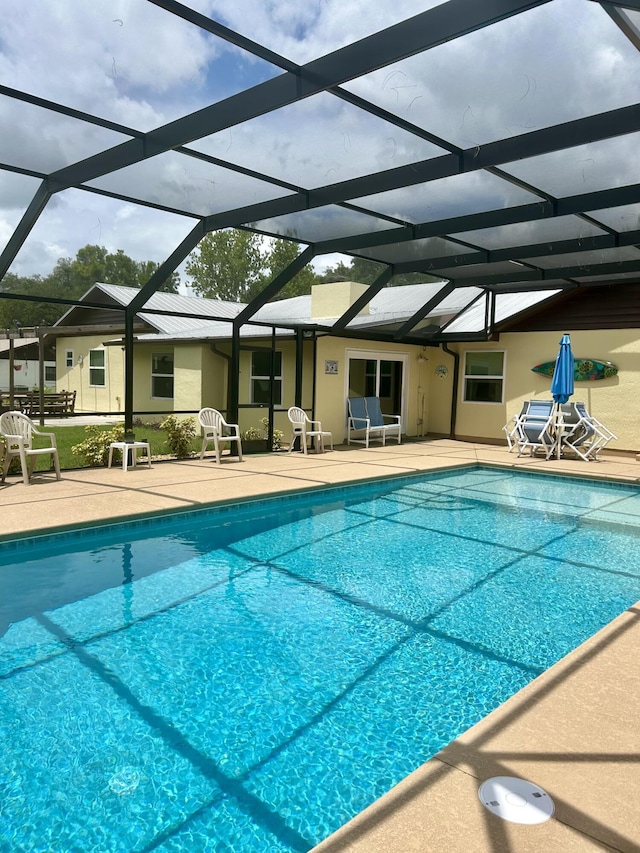 view of swimming pool with a lanai and a patio