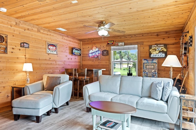 living room with wooden ceiling and wood walls