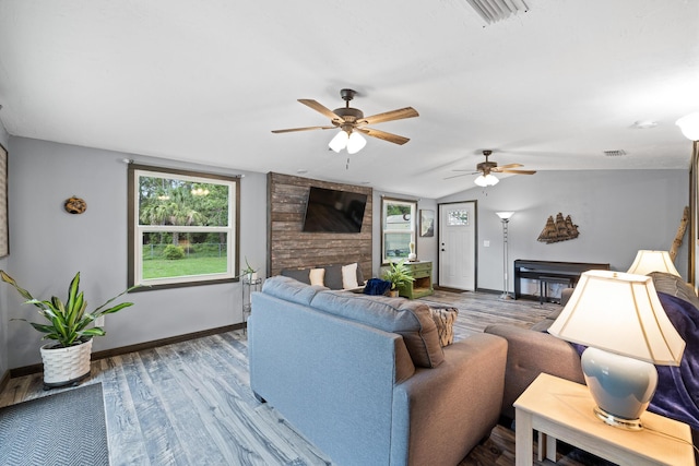 living room featuring a fireplace, ceiling fan, hardwood / wood-style floors, and lofted ceiling