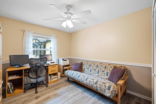 office area with ceiling fan, a textured ceiling, and light wood-type flooring