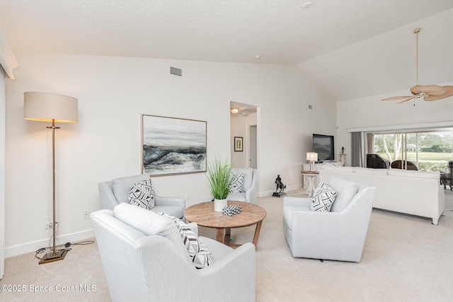 carpeted living room featuring ceiling fan and lofted ceiling