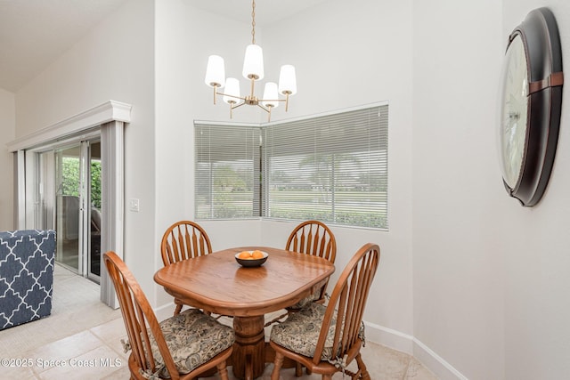 tiled dining room with high vaulted ceiling and a notable chandelier