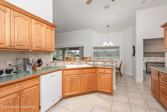 kitchen with backsplash, ceiling fan with notable chandelier, sink, light tile patterned floors, and dishwasher