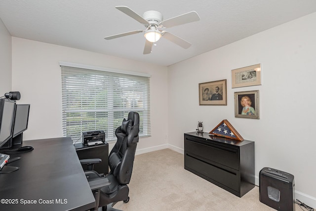 carpeted office featuring ceiling fan