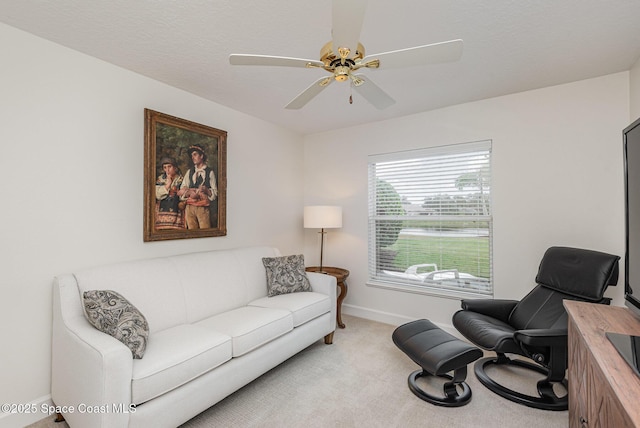 living room featuring ceiling fan and light colored carpet