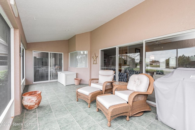 sunroom featuring vaulted ceiling