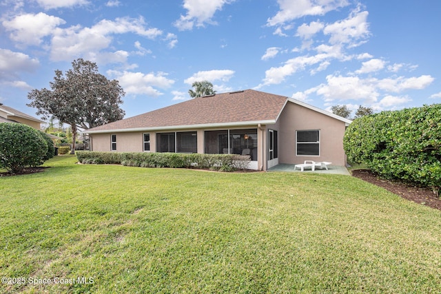 rear view of property featuring a yard and a sunroom