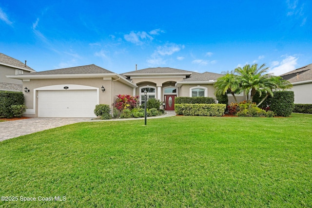 view of front facade with a front yard and a garage