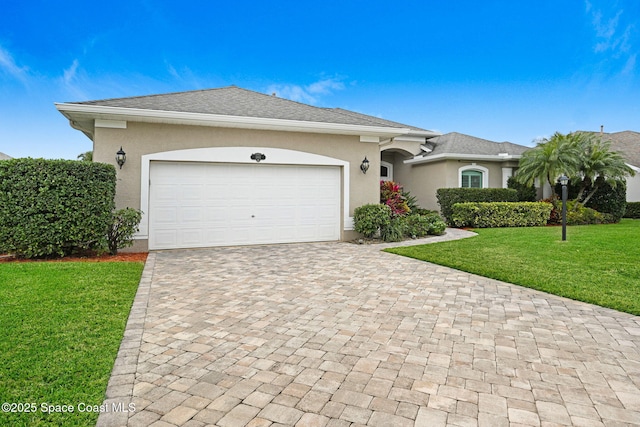 single story home featuring a front lawn and a garage