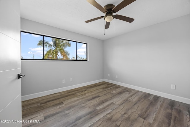 spare room with ceiling fan and dark wood-type flooring