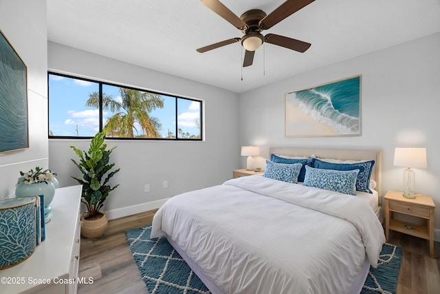 bedroom with ceiling fan and wood-type flooring