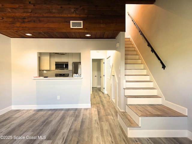 interior space featuring wood-type flooring and wooden ceiling