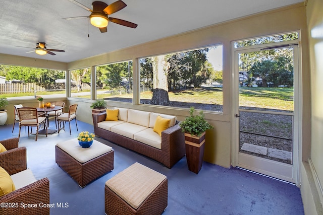 sunroom featuring ceiling fan and a healthy amount of sunlight