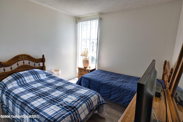 4700 Ocean Beach Blvd Unit 404, Cocoa Beach, FL 32931 - bedroom with a textured ceiling and wood finished floors