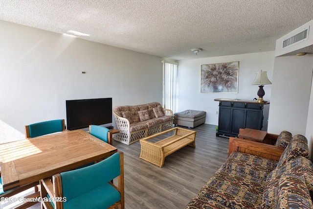 living room featuring dark hardwood / wood-style floors and a textured ceiling