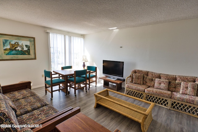 living room featuring dark hardwood / wood-style floors and a textured ceiling